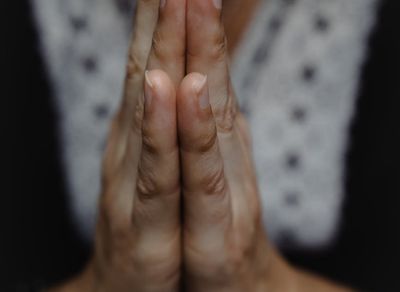 Close-up of hands in a specific yoga mudra gesture.